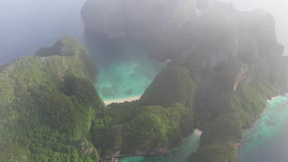 4k Aerial View Of Maya Bay Phi Phi Island Drone Flying Through The Clouds To Show Beach Sea 