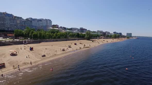 Aerial View Above Sandy Beach on City Quay on Shore of River