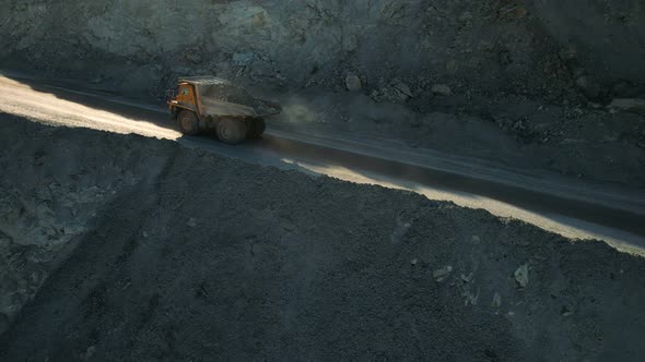 Mining truck is driving an opencast quarry.  Mining industry concept. alt