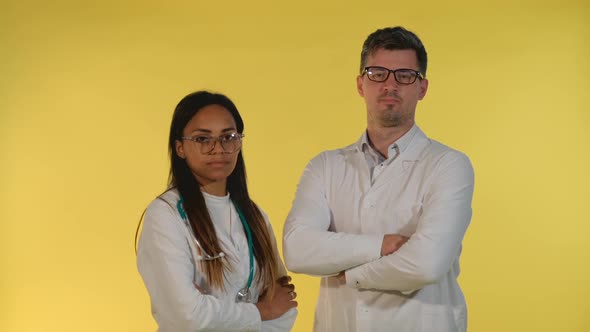 Mixedrace Male and Female Doctors Denying Something to the Camera alt