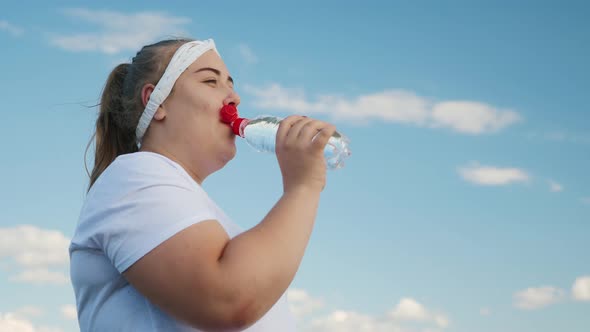 Fat Girl Drinks Water From a Bottle alt