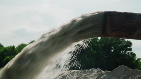 Wastewater from Large Rust Pipe Merge into Environment on background Forest alt