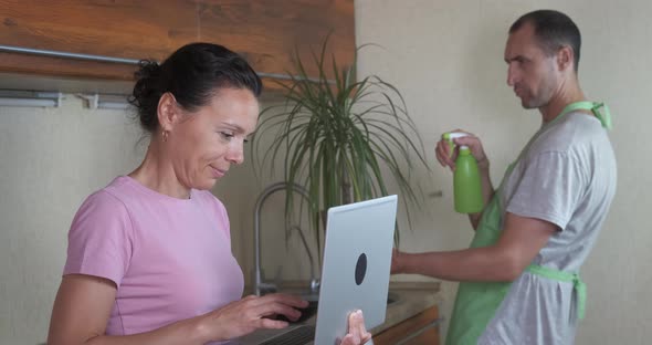 Couple work in the kitchen.  alt