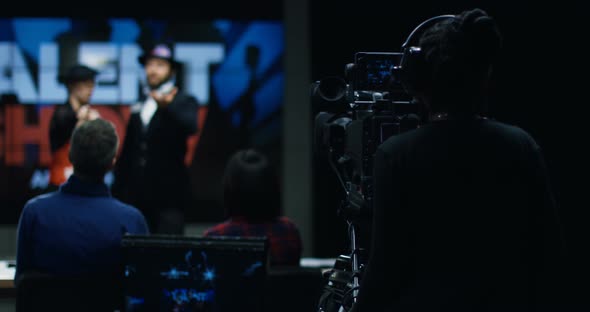 Young Woman and Man Acting at Talent Show alt