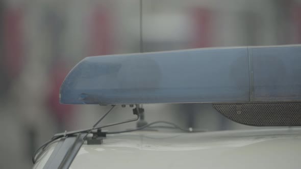 Flashing Flasher on the Roof of a Police Car. Blinker. Close-up. alt