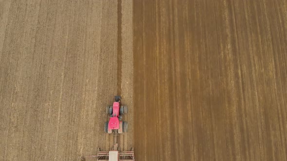 Aerial Tractor Works in the Field with Multifunctional Unit alt