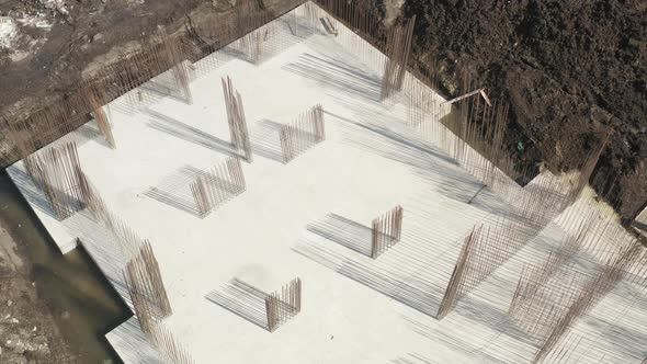 Metal Fittings with Laid Pipes are the Basis for Pouring the Foundation of a House with a Concrete alt