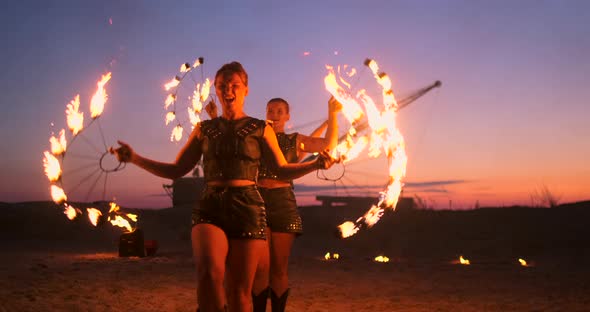 Professional Artists Show a Fire Show at a Summer Festival on the Sand in Slow Motion alt