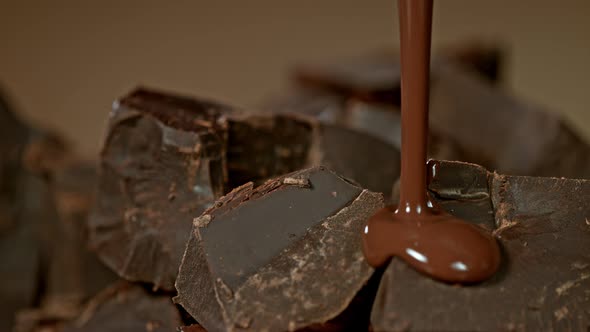 Super Slow Motion Shot of Pouring Melted Chocolate on Raw Chocolate Chunks at 1000 Fps alt