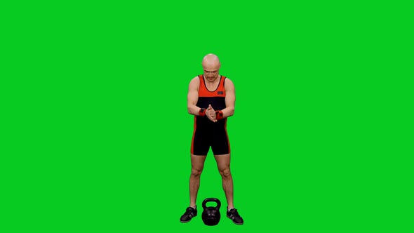 Male Athlete Pushing Kettlebell By One Hand on Green Screen
