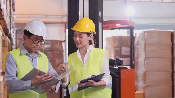 asian Male and Female Industrial Engineers in Hard Hats alt