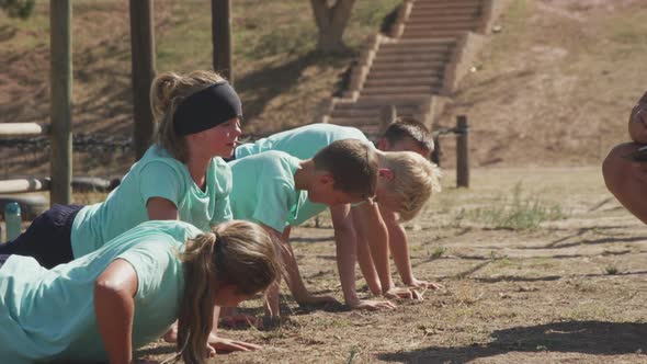 Group of Caucasian children training at boot camp alt