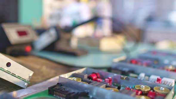 Slider Shot of a Connectors Component and Large Green Microcircuit in Workshop Laboratory alt
