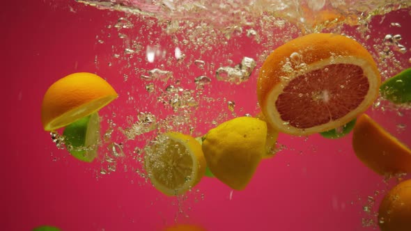 Mix of Exotic Citrus Fruits Falling Into Water in Slow Motion  Grapefruit Lemon Orange Lime alt