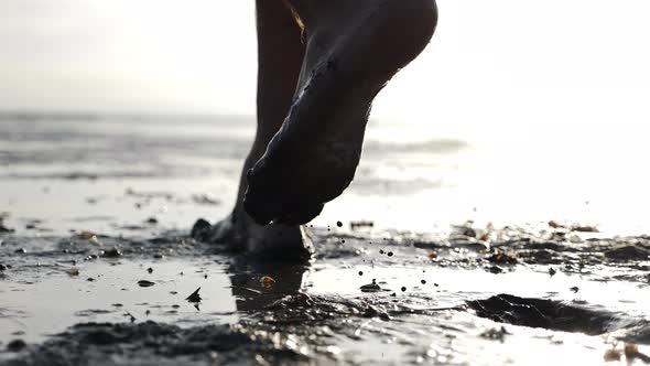 Cinematic Shot of Man with Dirty Feet Walking Barefoot Making Traces Near Pond