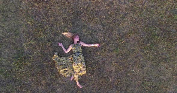 Beautiful woman lying in grass and enjoying alt