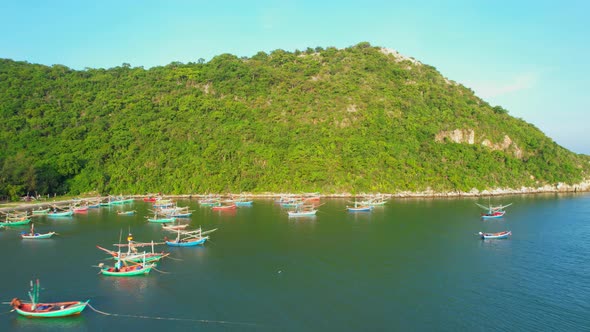 Many fishing boats on the coast beside the mountains, beautiful sea area in Thailand. alt