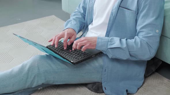 Close Up of a Concentrated Beaded Man Thinking and Typing with His Laptop
