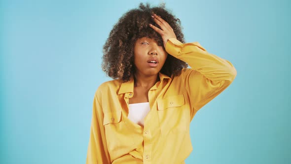 Darkskinned Female Making Facepalm Hand Gesture Rolling Her Eyes and Shrugging Shoulders Posing on alt