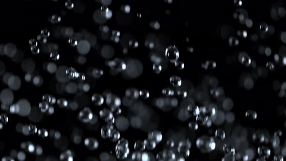 Super Slow Motion Shot of Falling Water Drops Isolated on Black Background at 1000 Fps. alt
