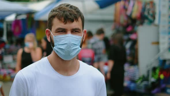 Man in Covid19 Facemask Walks Browsing Asian Public Market Flea Store Shopping alt