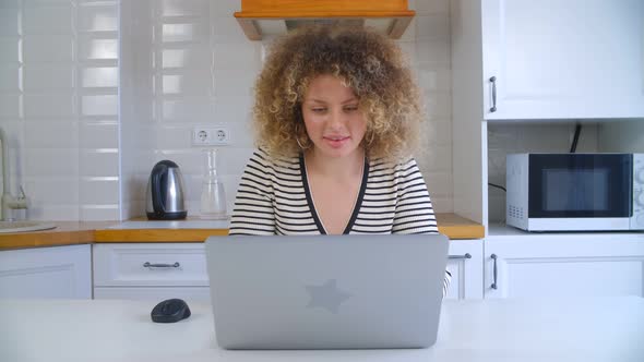 Young white female studying online with notebook computer at home on lockdown in 4k video alt