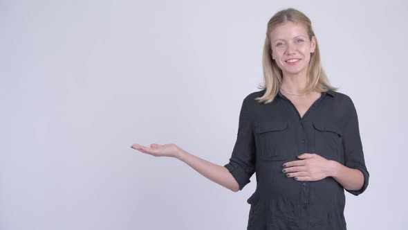 Young Happy Pregnant Businesswoman Talking While Showing Something alt