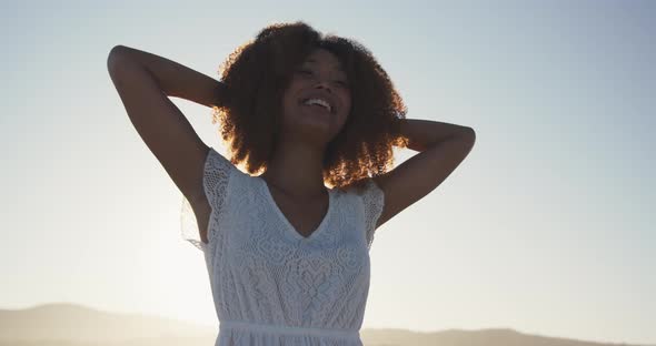 Portrait of African American woman enjoying at beach alt