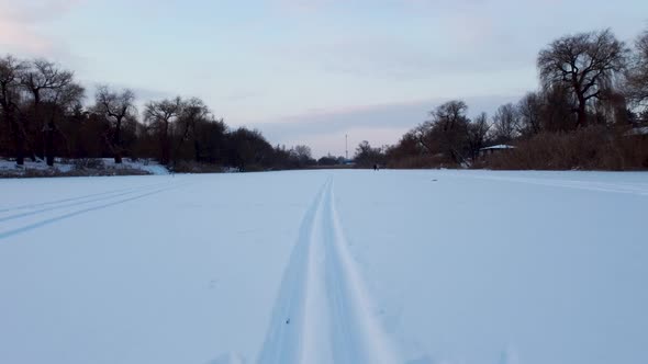 Cross-country wild ski track lines on snowy river