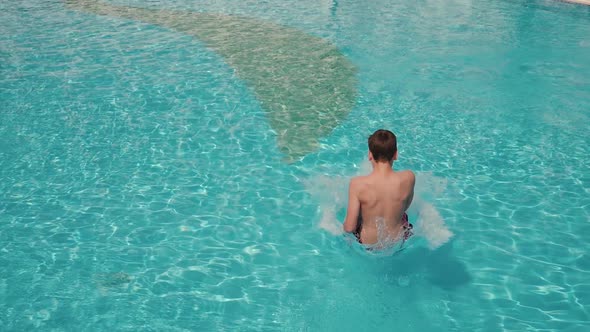 Guy Jumping in Pool