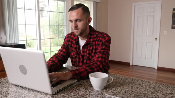 Man working on laptop at home