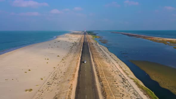 Driving on a scenic route surrounded by sea - drone view of dhanushkodi alt