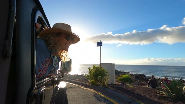 Woman looking out of car window on a road trip