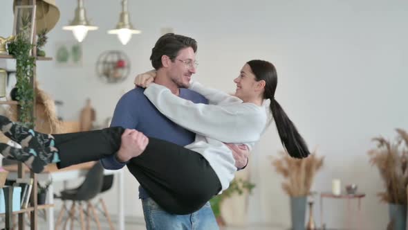 Man Moving in Circle While Holding Woman in Arms alt