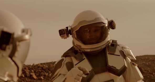 Astronauts Bumping Fists and Talking on Mars alt