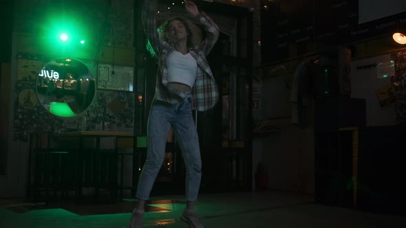 Carefree Crazy Girl Dancing on the Dance Floor in a Nightclub alt