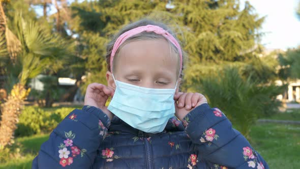 Girl Takes Off a Medical Mask on the Street and Smiles