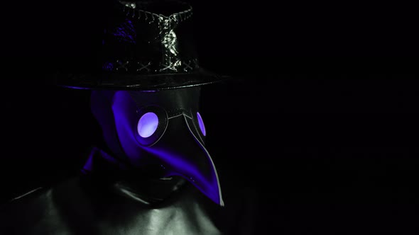 Portrait of Plague Doctor with Crow-like Mask Isolated on Black Background. Creepy Mask, Halloween alt