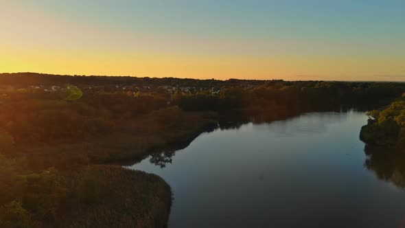 Beautiful Sunset Sky Dramatic Landscape Small Residential Area Community Along the River in a Sunny alt