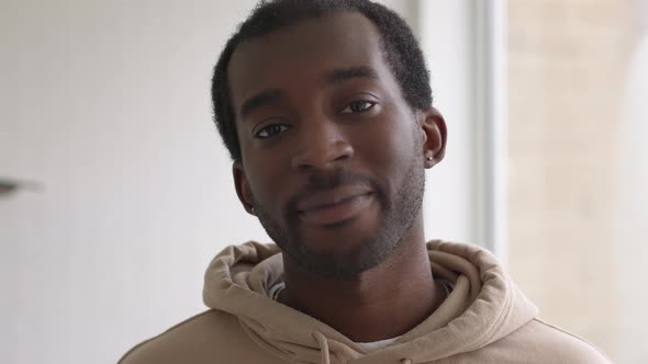 Close Up Portrait Of Smiling Young Man Standing In New Home