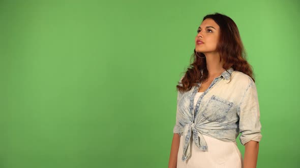 A Young Beautiful Caucasian Woman Looks Around  Green Screen Background