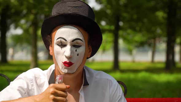 Close-up of a Mime Drinks Alcohol Outdoors. Bad Habits, Stock Footage