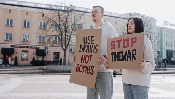 Young People Stand on the Street with Posters Calling to Stop the War