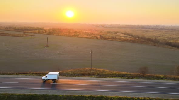 Aerial View of Cargo Trucks Driving on Highway Hauling Goods alt