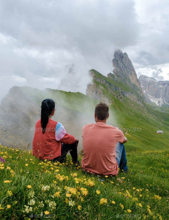 couple on vacation hiking in the Italian Dolomites, Amazing view on Seceda peak. Trentino Alto Adige - Stock Photo - Images