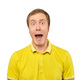 Surprised young man with funny facial expression in yellow T-shirt, white isolated background - PhotoDune Item for Sale