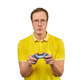 Geek gamer in glasses and yellow T-shirt with gamepad, excited video game player isolated on white - PhotoDune Item for Sale