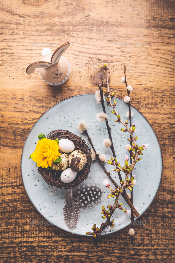 Easter table setting with spring flowers and cutlery on wooden table - Stock Photo - Images