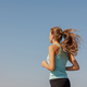portrait of sporty woman jogging in morning on ocean. young confident woman runs - PhotoDune Item for Sale