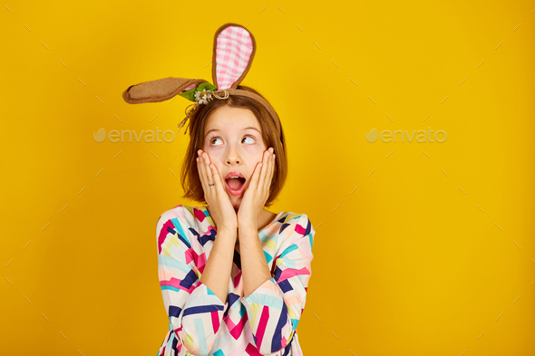 Happy playful teenager girl wearing bunny ears - Stock Photo - Images